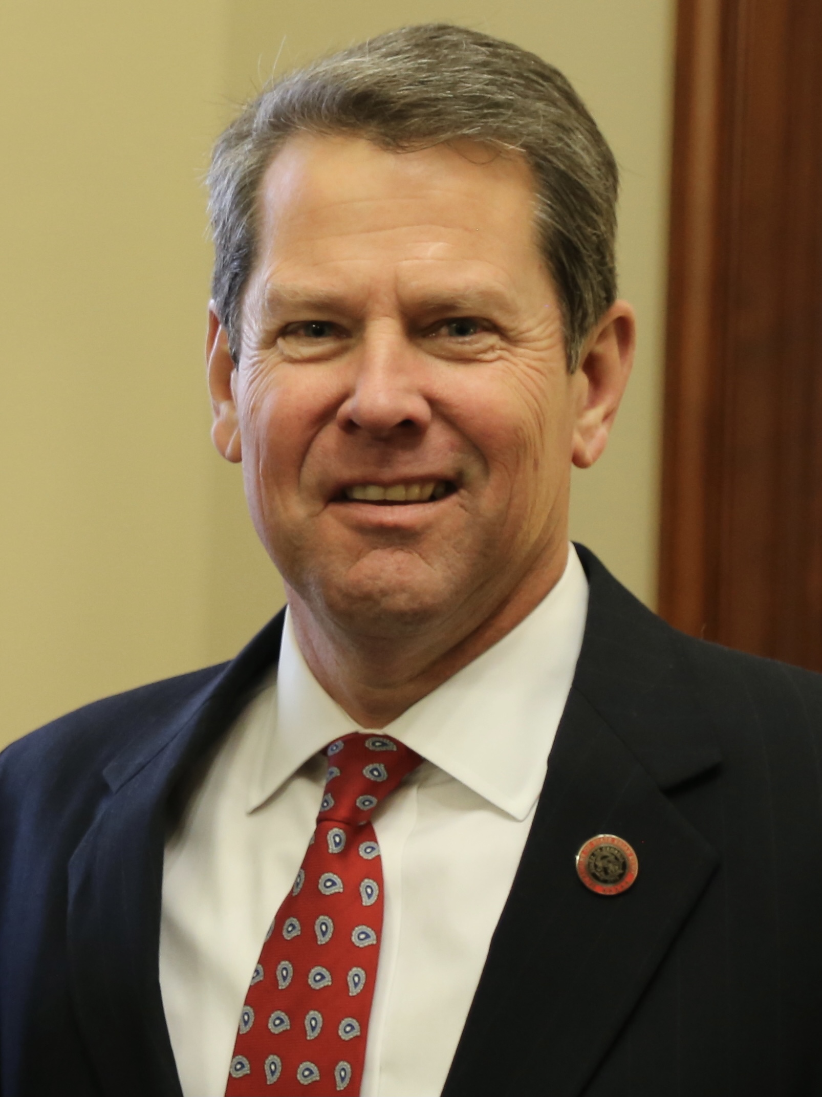 Georgia Governor Brian Kemp speaking at a podium