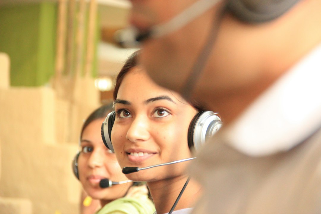 Emergency dispatcher wearing a headset at a call center console.