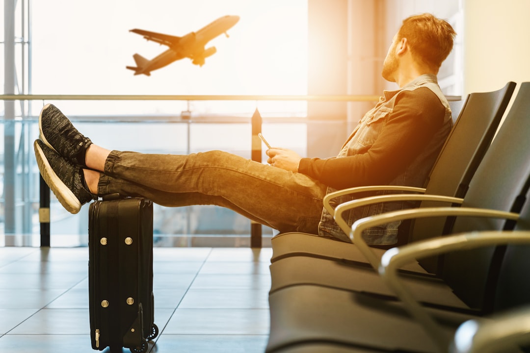 Passengers wait in Atlanta airport terminal during flight delays.