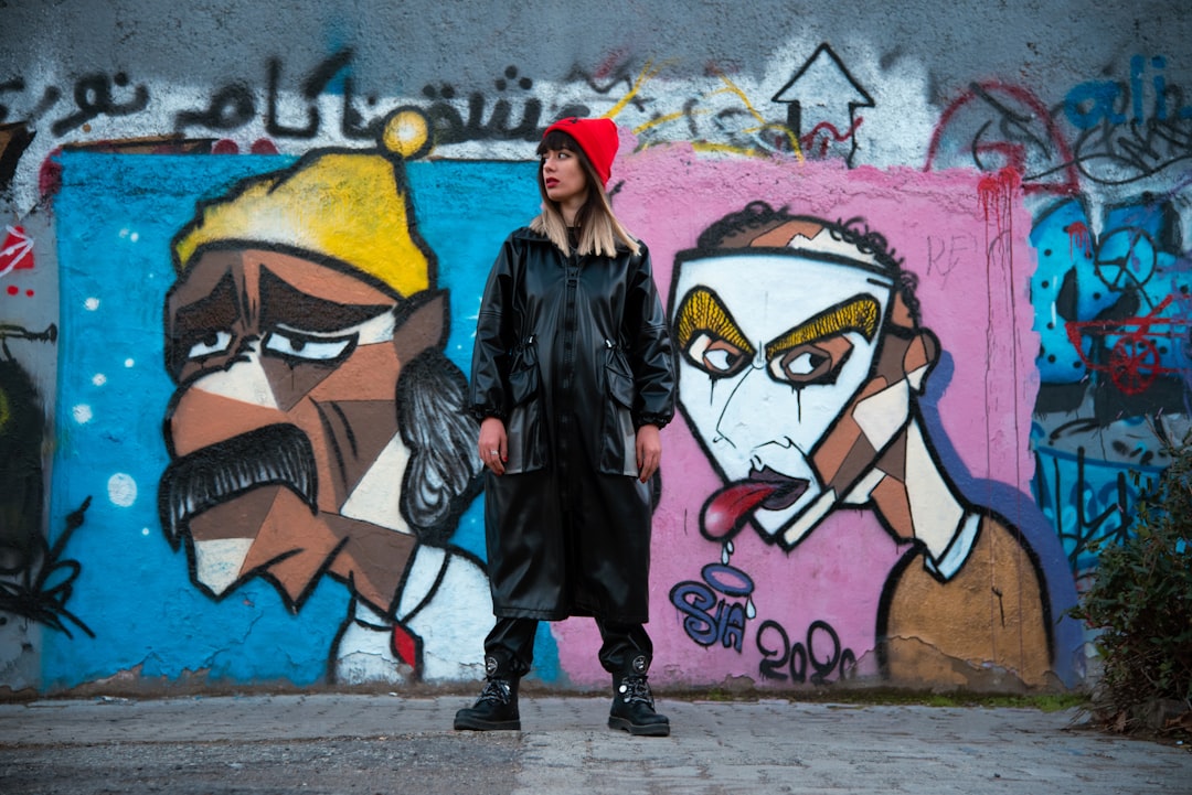 A large painted mural portrait of rapper Macklemore on a wall in Gaza.