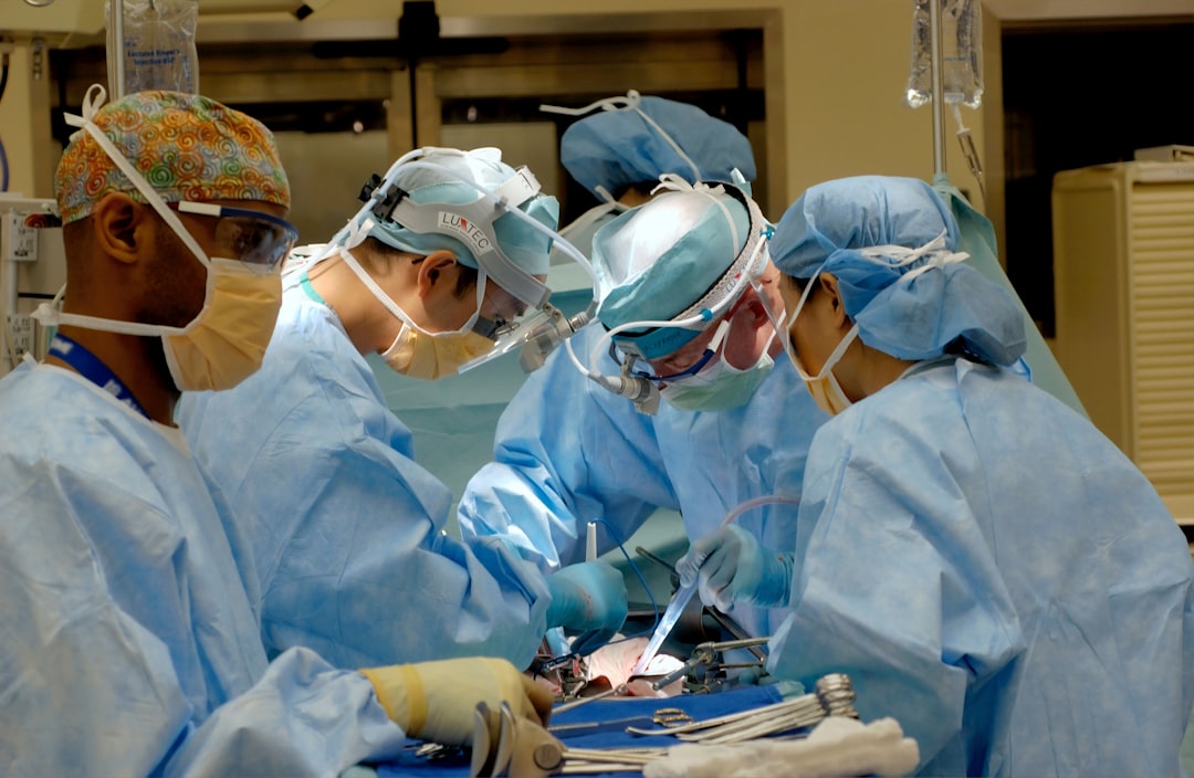 Surgeons performing a kidney transplant operation in a hospital operating room