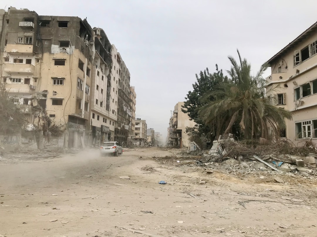 Armed Palestinian militants standing in a Gaza street amid rubble and damaged buildings
