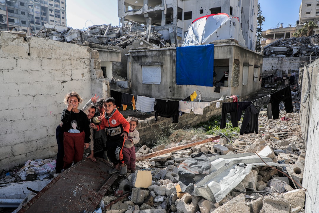 A Palestinian family mourns near the rubble of a building destroyed by an Israeli airstrike in Deir el-Balah, Gaza.