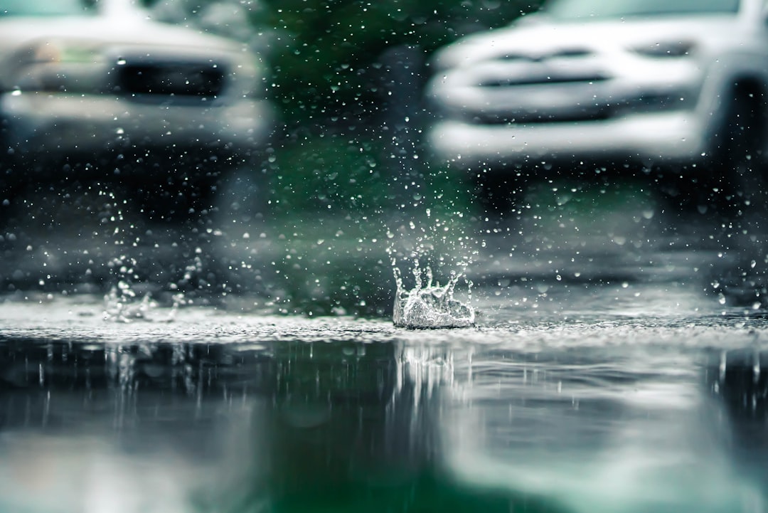 Flooded residential street in metro Atlanta with cars partially submerged after severe thunderstorms.