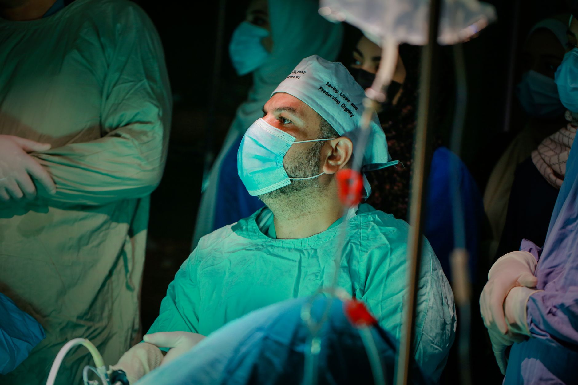 A darkened hospital ward in Gaza during a power outage, with medical staff working amid fuel shortages and the ongoing conflict