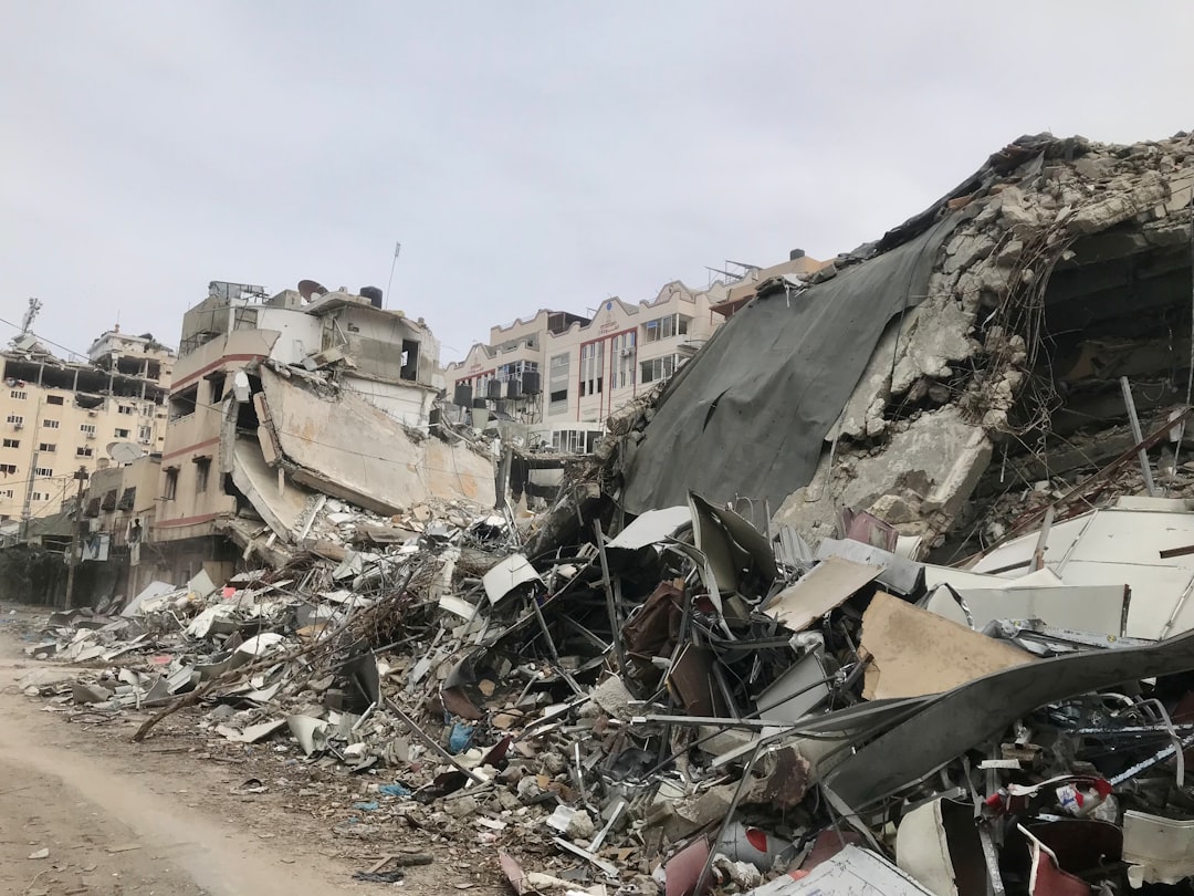 An excavator clears rubble amid destroyed buildings in Gaza, where a UN expert warns war crimes evidence may be lost.