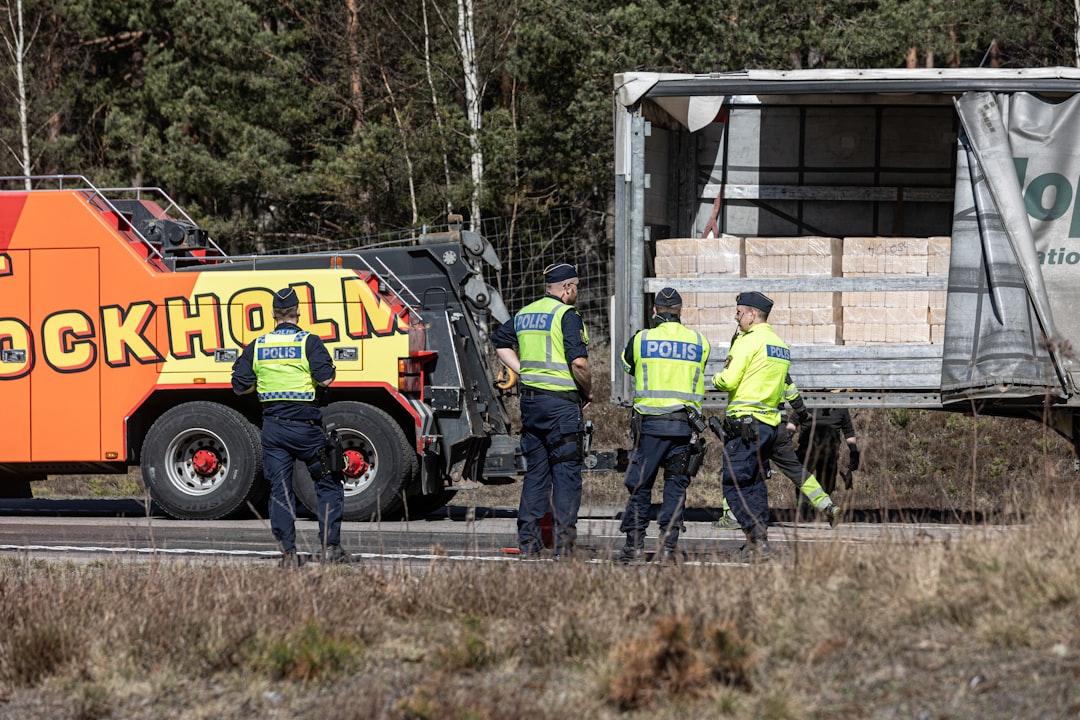 Police officers inspect a tow trailer where two young sisters were found hidden in Atlanta.