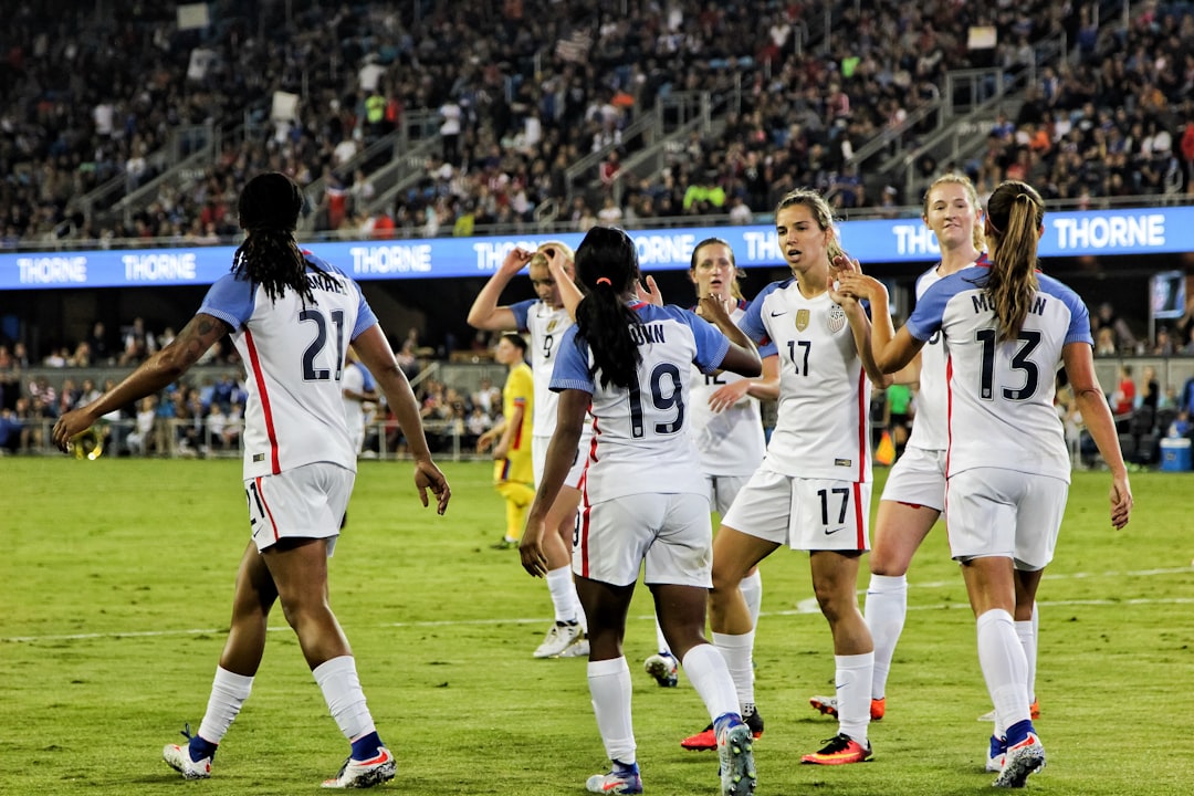 A United States men's national soccer team player in a white USA jersey controls the ball during a World Cup match