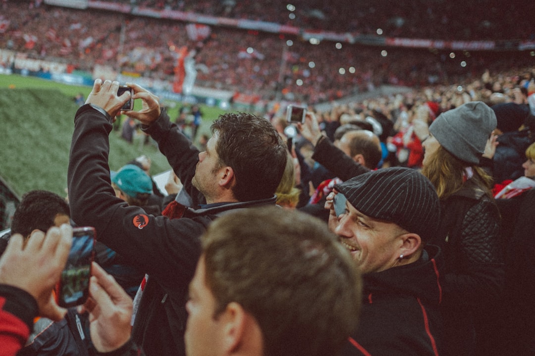 Soccer fans cheering and celebrating in a packed stadium during a World Cup match